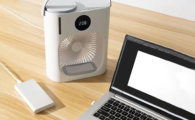 در این عکس یک پنکه رومیزی شیائومی مدل Xiaomi Lydsto cl08 در کنار یک پاور بانک و یک لپ‌تاپ نمایش داده شده است.